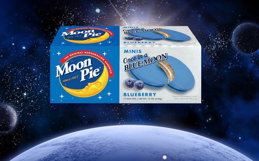 Packaging of Blueberry MINI MoonPies with space-themed background, showing boxes of Mini MoonPies against an astronaut backdrop.